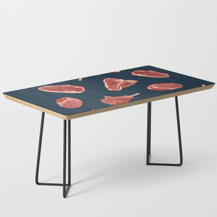 Pattern of fresh beef steaks over blue Coffee Table