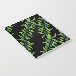 Green Flowing Seaweed on Black Notebook