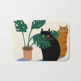 Black cat & orange tabby cat with Monstera plant Bath Mat