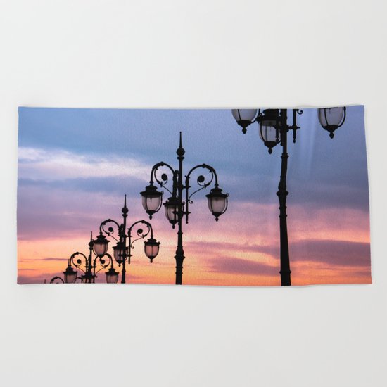 city lights in the evening sky Beach Towel