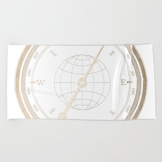 Gold Compass on White Beach Towel