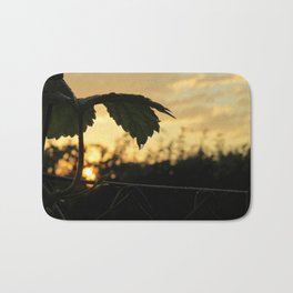 When Everything Starts Again - golden sunrise with leaf silhouette Bath Mat