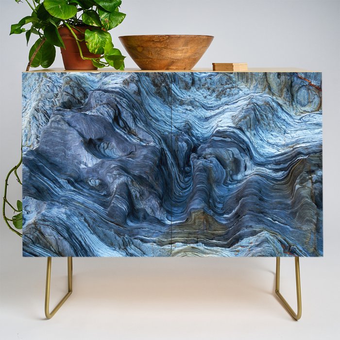 Detail of a rock with variants of blue. Rock full of curves and smooth cuts resulting from the erosive effect of sea. Close up rocks, texture dramatic and colorful erosional water formation. Stone Credenza