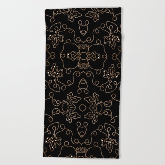 Elegant gold embellishments on black Beach Towel
