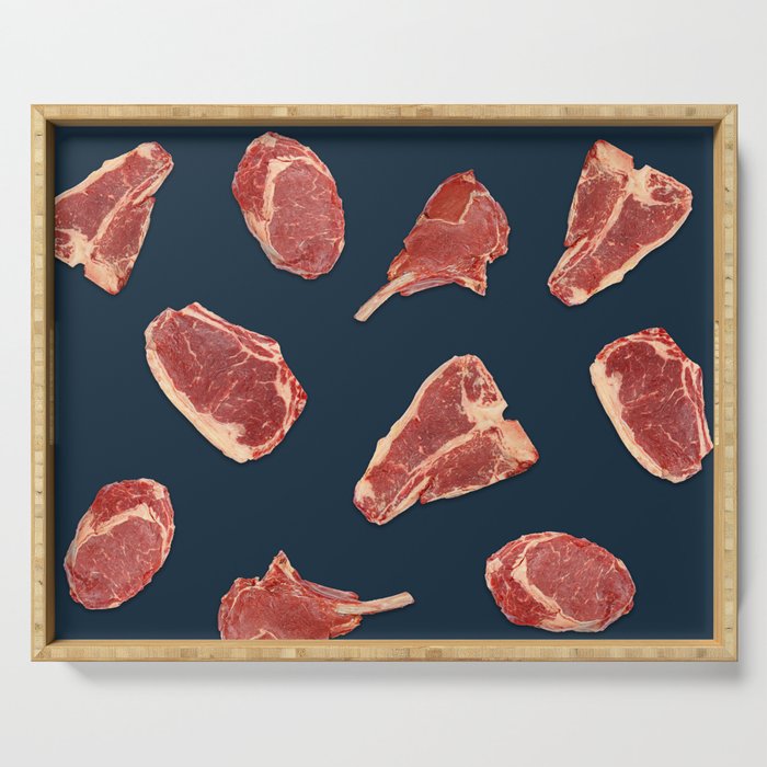 Pattern of fresh beef steaks over blue Serving Tray