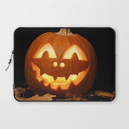 Carved Pumpkin for Halloween and Autumn Leaves on Black Background Laptop Sleeve