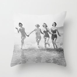 Four women run in water on the beach Throw Pillow