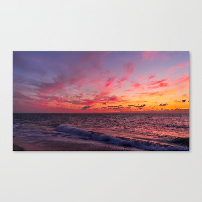 Magical sunset colors in the sky above the sea Canvas Print