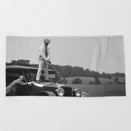 Pro golfer hitting golf ball off vintage car hood ornament on a dare par one 18th hole funny black and white golf sport photograph - photography - photographs Beach Towel