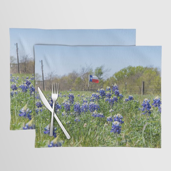 Bluebonnet flowers blooming by road with Texas flag in background Placemat