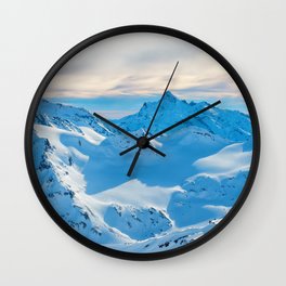 Mountains with snow peaks and sunset sky Wall Clock