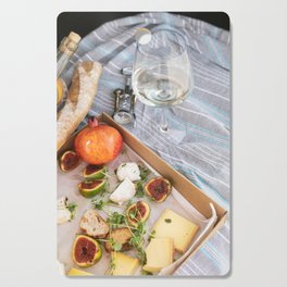Different delicious food and glass of wine on picnic Cutting Board