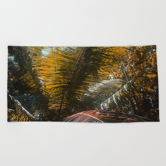 Into the Seychellian leaves Beach Towel
