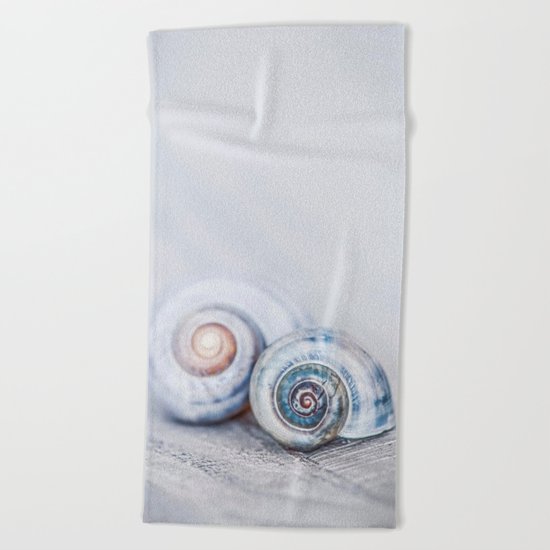 Blue Shells on white washed wood in soft pastel blues Beach Towel