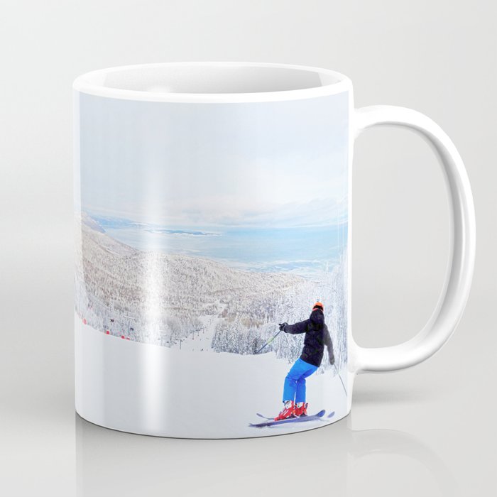 Skier at a ski resort with snowy mountain and lake Coffee Mug