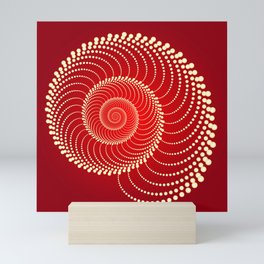 Abstract spiraling dots on red Mini Art Print