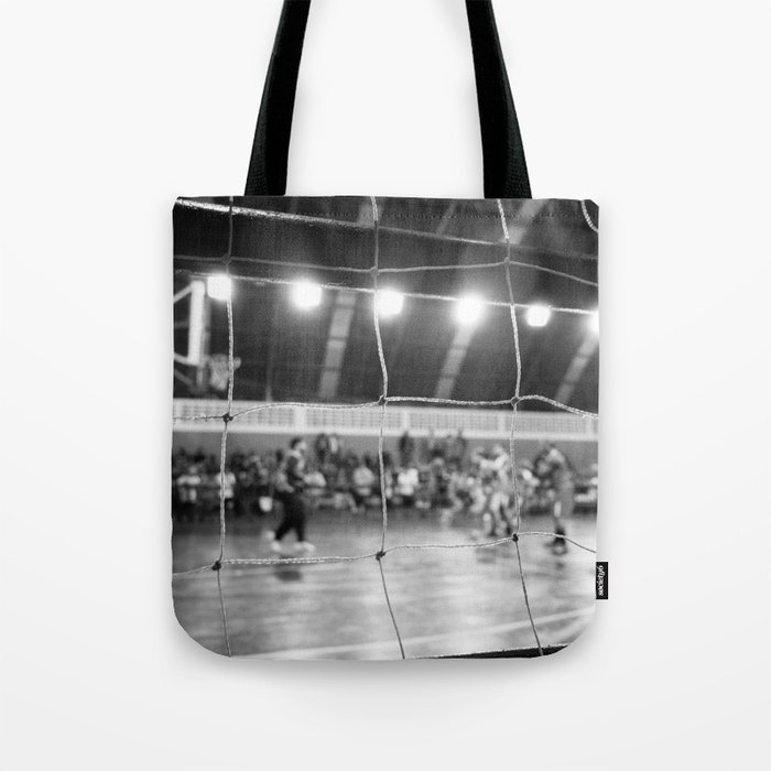 Black and White Photo of a handball game from behind the net Tote Bag