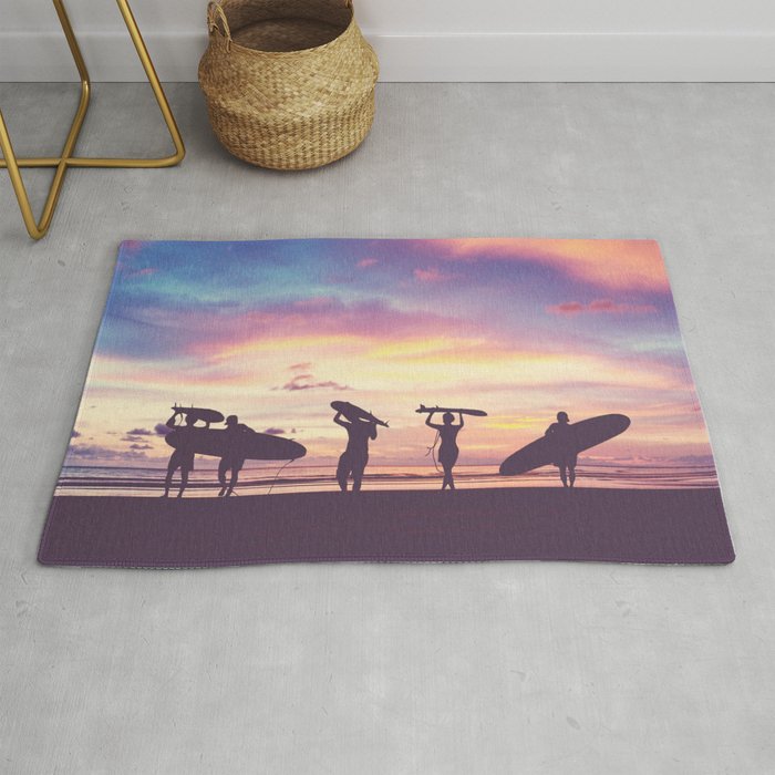Silhouette Of surfer people carrying their surfboard on sunset beach, vintage filter effect with soft style Rug