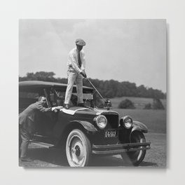 Pro golfer hitting golf ball off vintage car hood ornament on a dare par one 18th hole funny black and white golf sport photograph - photography - photographs Metal Print