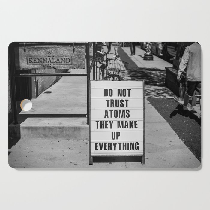 Do not trust atoms ... they make up everything humorous funny sign black and white photograph - photography - photographs by Marcela McGreal Cutting Board