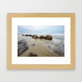Impressive Moeraki boulders in the Pacific Ocean waves Framed Art Print