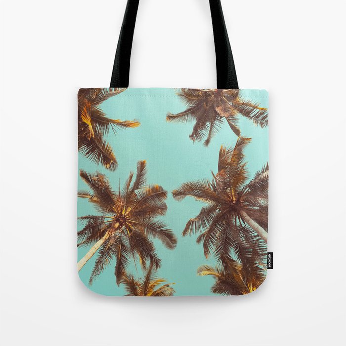 Tropical palm tree with blue sky and cloud abstract background. Summer vacation and nature travel adventure concept. Pastel tone filter effect color style.  Tote Bag