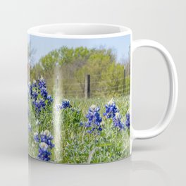 Bluebonnet flowers blooming by road with Texas flag in background Coffee Mug