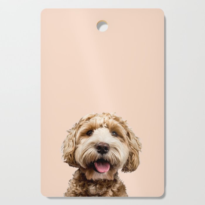 Happy Goldendoodle on Pastel Pink Background Cutting Board