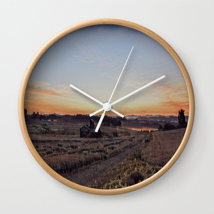 Countryside at sunset Wall Clock