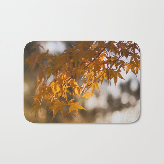 Autumnlights - Gold marple leaves at sparkling backlight Bath Mat