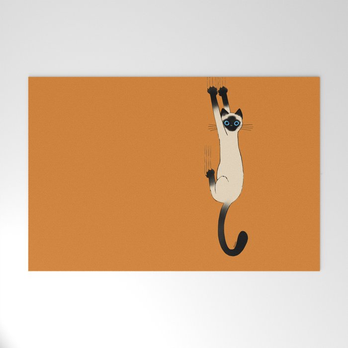 Siamese Cat Hanging On Welcome Mat