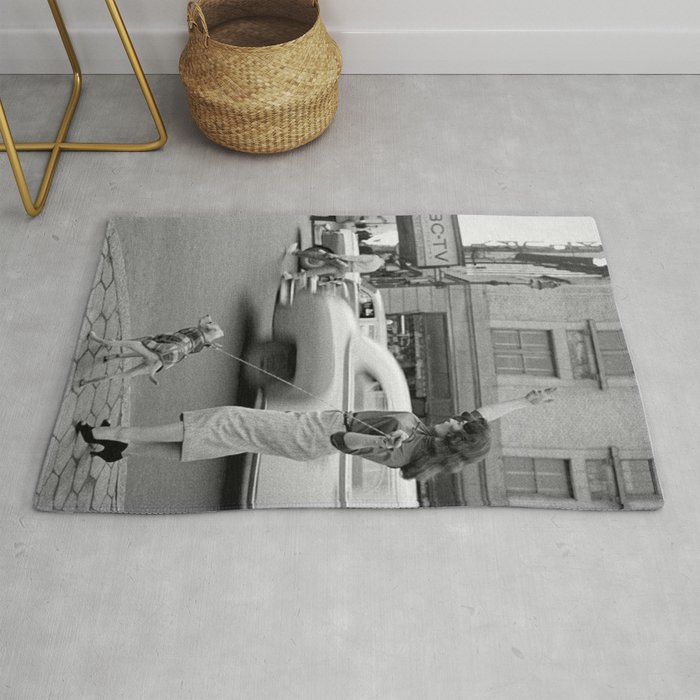 Young woman with pet dog hailing a yellow cab taxi New York City portrait black and white photograph - photography - photographs Rug