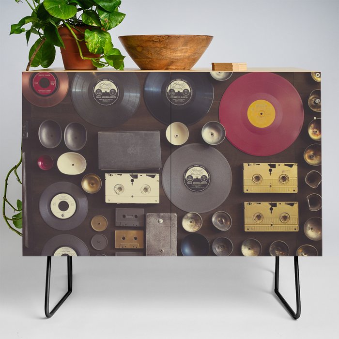 Music. Vintage wall with vinyl records and audio cassettes hung. Credenza