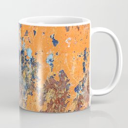 Orange metal background with cracked, peeling paint with stains of blue paint and rust spots. Coffee Mug