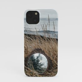 Vintage mirror on seaside reflects forest and sky. iPhone Case