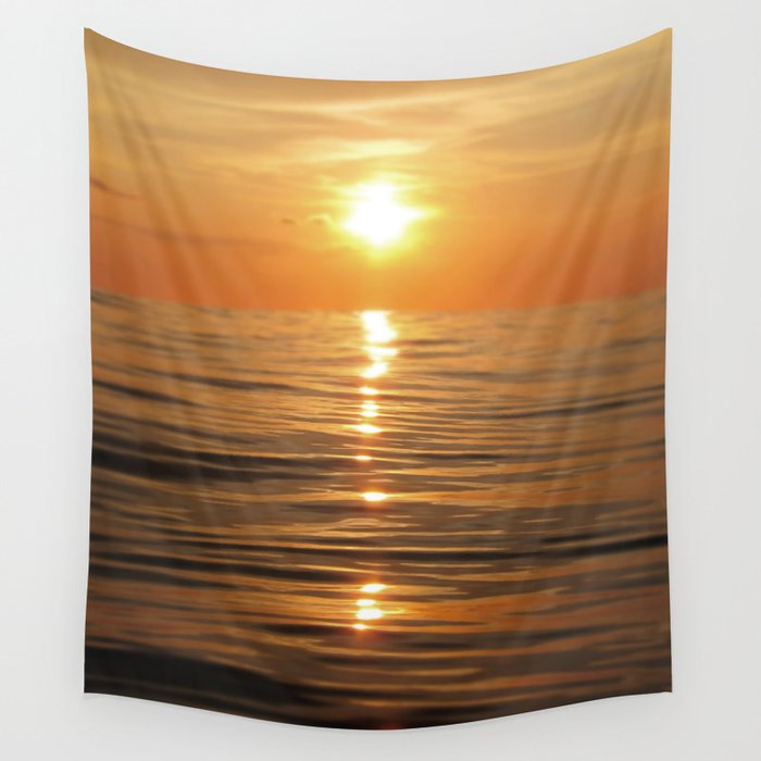 Sun setting over calm waters Wall Tapestry