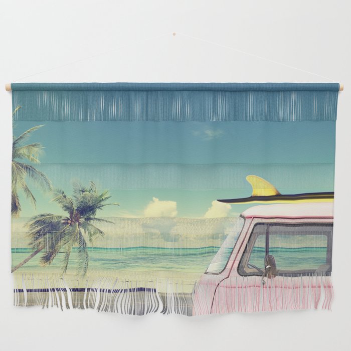 Vintage car in the beach with a surfboard on the roof Wall Hanging
