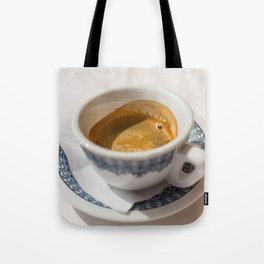 Italian espresso coffe with cream on a table outside a bar in Italy. Tote Bag