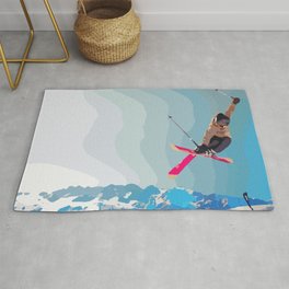 Man jumps with skies on piste with mountains and sky background Rug