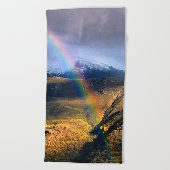 "Rainbow through the snow mountains". Into the storm. Beach Towel