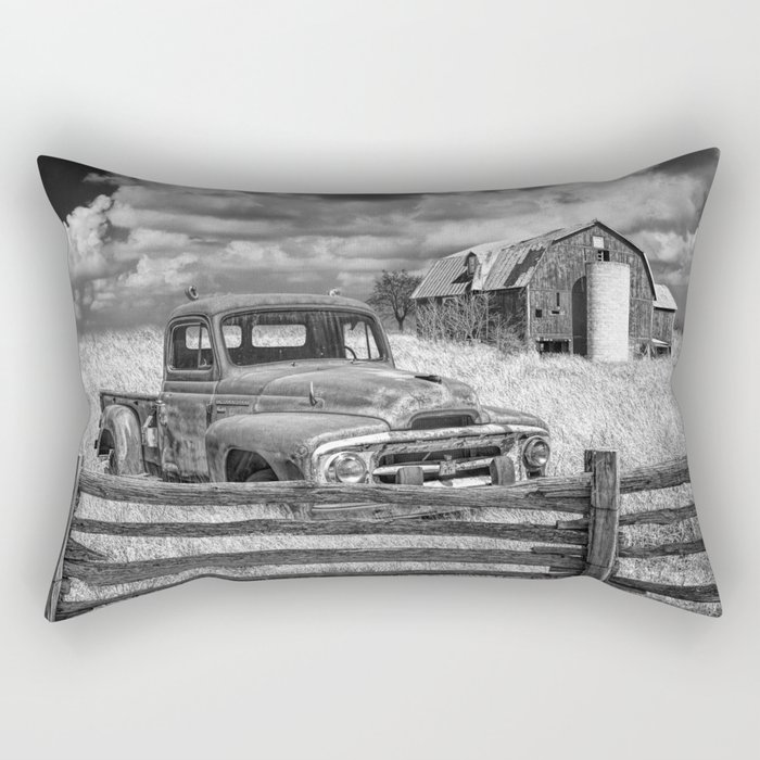Black and White of Rusted International Harvester Pickup Truck behind wooden fence with Red Barn in Rectangular Pillow