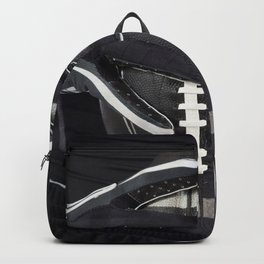 Black gloved hands holding a black American Football Backpack | White, Holding, Play, Sport, Gloved, Athletic, Pasttime, Grip, Black, Gloves 