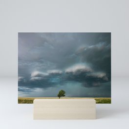 a single tree in a thunderstorm Mini Art Print