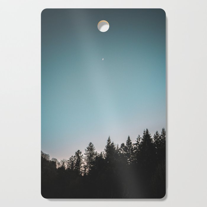 Moonlight trees sunset blue Cutting Board