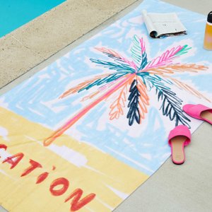 beach towel with an illustration of a palm tree