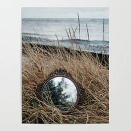 Vintage mirror on seaside reflects forest and sky. Poster