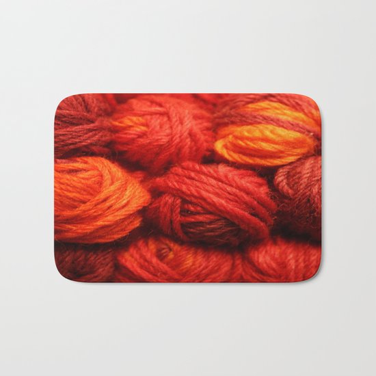 Many Balls of Wool in Shades of Red Bath Mat