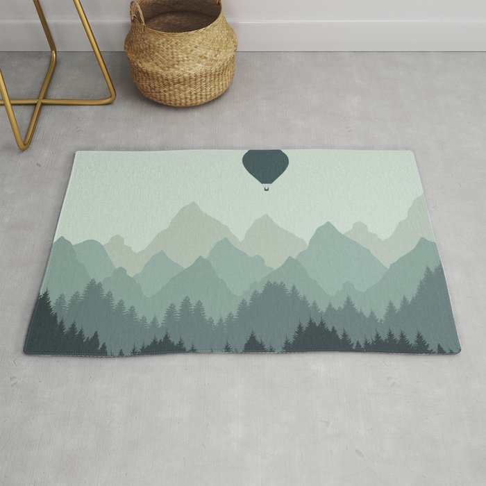 Hot Air Balloon flies over the Mountains Rug