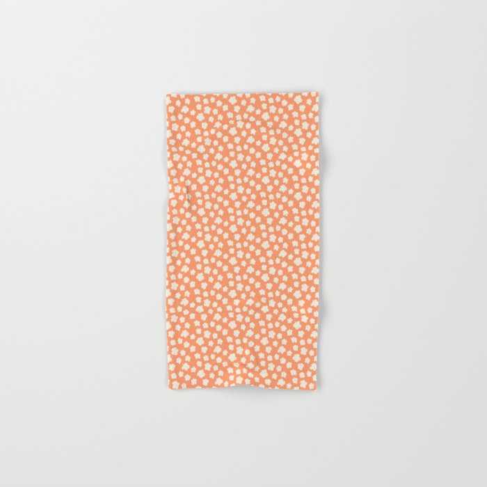 small silhouette flowers cream on orange  Hand & Bath Towel