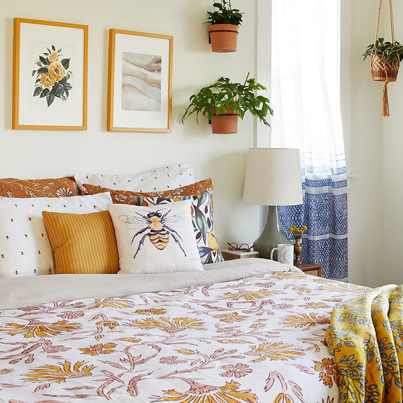 king size bed with yellow and white floral patterned comforter
